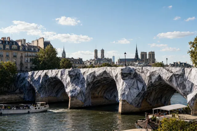 Illustration of JR’s La Caverne du Pont Neuf installation transforming the historic Paris bridge into a giant rocky cave